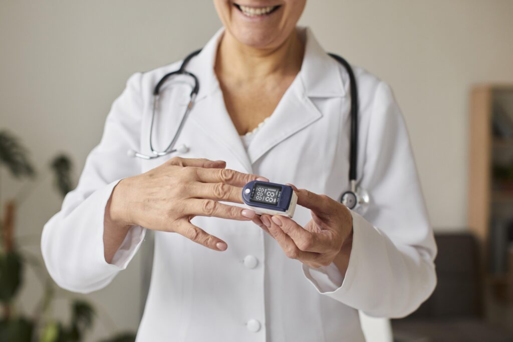smiley-elder-covid-recovery-center-female-doctor-using-oximeter